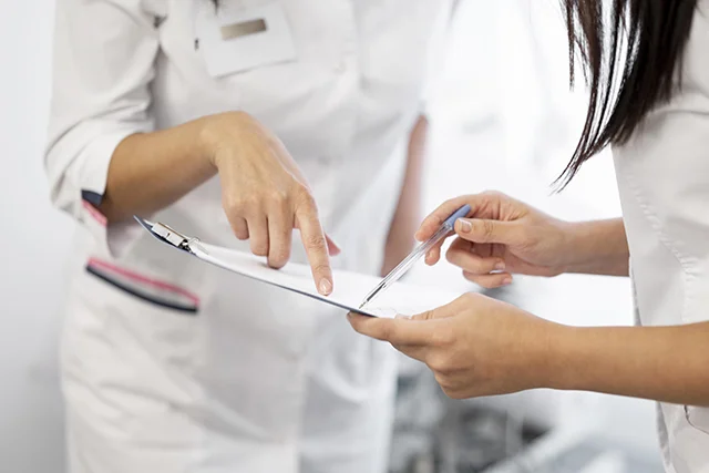 Salon staff updating client records on a tablet